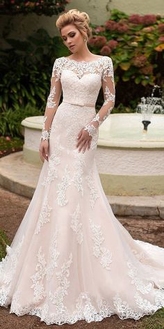 a woman in a wedding dress posing for the camera with her hands on her hips