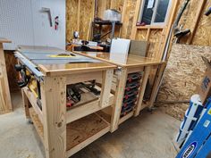 a workbench with tools on it in a garage being built by someone else