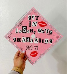 someone is holding up a pink graduation cap with the words get in, i see we are graduating