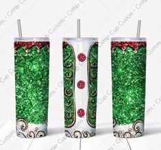 the tumbler cup is decorated with green glitter and red bows, as well as two straws