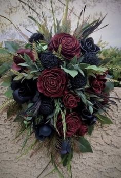 a bridal bouquet with red and black flowers