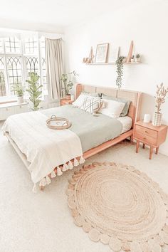 a bed room with a neatly made bed and a rug