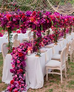 the table is covered with flowers and candles