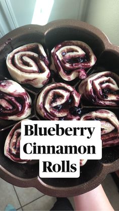 blueberry cinnamon rolls in a cast iron skillet with the words, blueberry cinnamon rolls