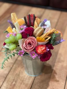 a vase filled with lots of different types of food on top of a wooden table