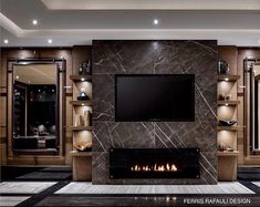 a living room with a large fireplace and tv on the wall in front of it