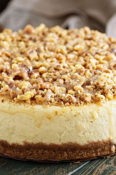 a cheesecake with walnuts on top sitting on a table