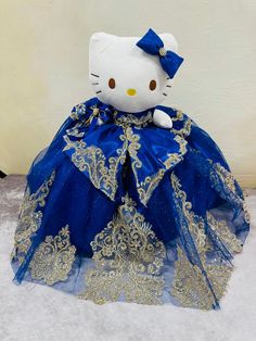 a hello kitty doll dressed in blue and gold