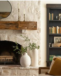 a living room with a fire place and bookshelf in it's corner