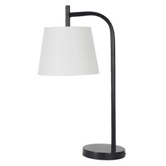 a black lamp with a white shade on it