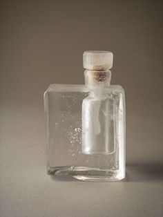 an empty glass bottle sitting on top of a table