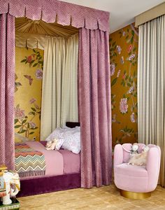 a bedroom decorated in pink and gold with floral wallpaper