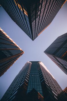 looking up at tall skyscrapers from the ground