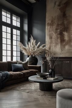 a living room filled with furniture and a large vase on top of a coffee table