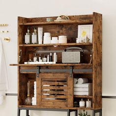 a wooden shelf filled with lots of bathroom items