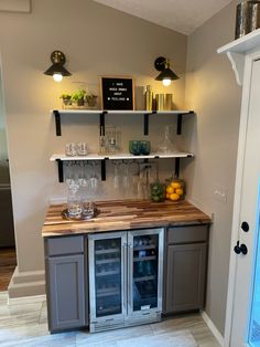 a kitchen area with shelves, counter and refrigerator