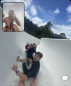 a group of people riding on top of a water slide