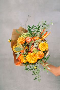 a person holding a bouquet of flowers in their hand