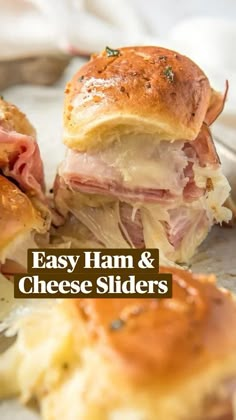 ham and cheese sliders on a plate with text overlay that reads easy ham and cheese sliders