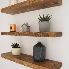 two wooden shelves with pots and plants on them