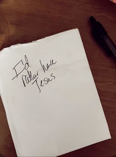 a piece of paper with writing on it next to a cup of coffee and pen