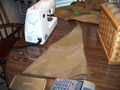 a sewing machine sitting on top of a wooden table next to a calculator