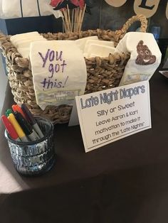 there is a basket on the table with some pens and pencils in front of it