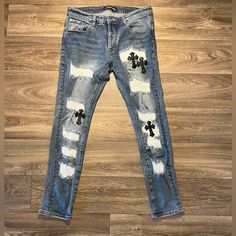 Elevate Your Wardrobe With These Rare Chrome Heart Denim Skinny Fit Jeans. The Distressed Detailing And Embroidered Accents On The Heart And Cross Theme Gives A Unique 90s Vibe To The Piece. These Pre-Owned Jeans Feature A Button Closure, Light Fabric Wash, And 30 In Inseam. Crafted From Quality Leather Material, These Blue Jeans Have A Waist Size Of 32 In And Fit True To Size. The Slim Fit And Pockets Are Perfect For A Modern And Stylish Look. These Jeans Are A Must-Have For Any Fashion-Forward Chrome Hearts Jeans, Chrome Hearts Leather, Heart And Cross, Leather Cross, 1 Of 1, Chrome Hearts, Leather Material, Waist Size, Fit Jeans