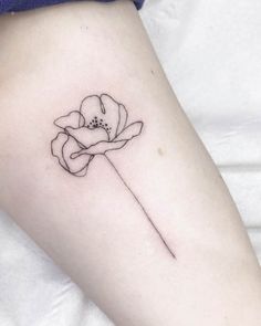 a single flower tattoo on the right side of the leg, it is black and white