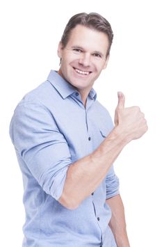 a man giving the thumbs up sign with his hand and smiling at the camera while standing against a white background