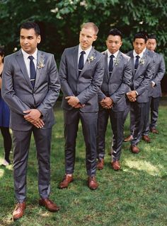 a group of men in suits standing next to each other