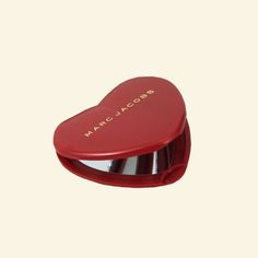 a heart shaped box with the word marcla cors on it's lid