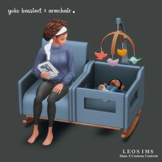 a woman sitting on a blue chair with a baby in it's crib