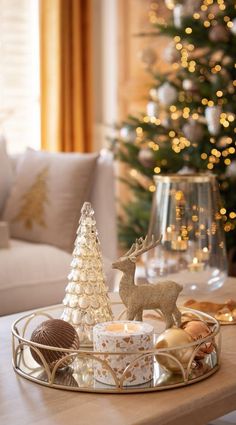 a christmas tree and other decorations on a coffee table