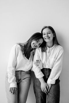 two young women are posing for a black and white photo with their arms around each other