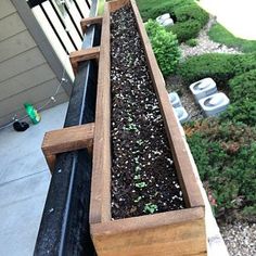 a wooden planter filled with lots of dirt