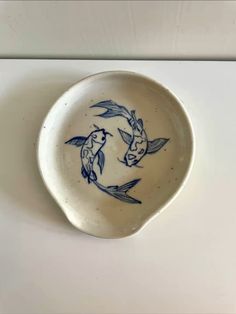 a blue and white bowl with two birds on it