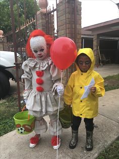 two children dressed up as clowns holding balloons