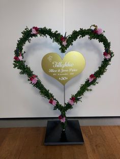 a heart shaped display with flowers on it