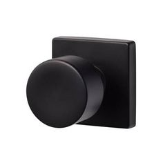 a black knob on the side of a wall