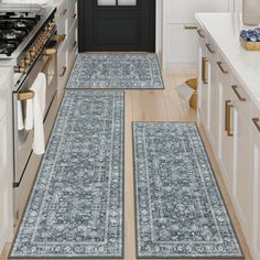 two blue rugs in the middle of a kitchen