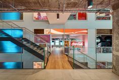 the inside of a building with stairs and coca cola signs