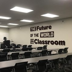 an empty classroom with desks and chairs in front of a wall that says the future of the world is this classroom