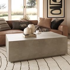 This modern concrete coffee table embodies minimalistic elegance with its sleek, rectangular shape and matte finish. Crafted from durable concrete, it offers a contemporary aesthetic that complements various décor styles. Its clean lines and robust structure create a striking focal point in any living space. Perfectly suited for modern interiors or exterior spaces, this coffee table enhances your lounge area with understated sophistication. AllModern Color: Gray AllModern Polly 51" Concrete Coff Concrete Tables, Concrete Coffee Table, Grey Coffee, Coffee Table Grey, Stone Concrete, Outdoor Coffee Table, Concrete Table, Brown Stone, Concrete Design