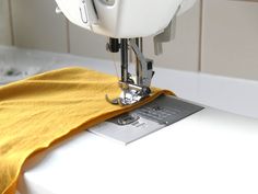 a sewing machine with a yellow cloth on it