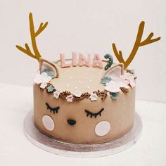 a cake decorated with deer antlers and flowers