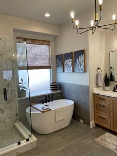 a bathroom with a large tub, sink and shower stall in it's corner