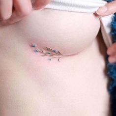 a woman's stomach with small blue flowers on it