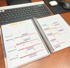 a desk with a keyboard, mouse and calendar