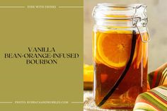 a glass jar filled with orange - infused bourbon sits on a table next to a striped napkin